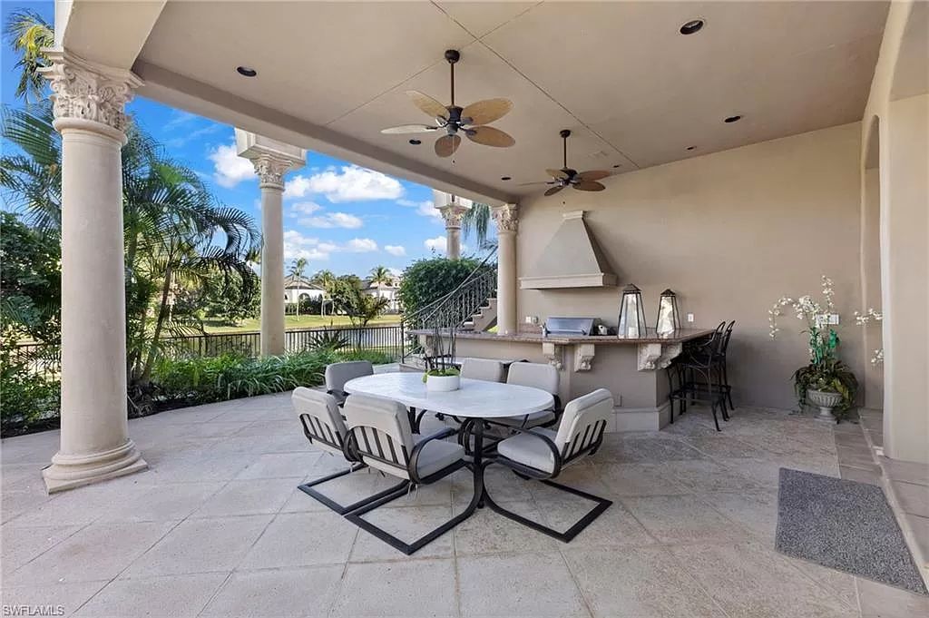 Welcome to the epitome of luxury living at 7310 Tilden Ln in Bay Colony Shores, Naples, Florida. This magnificent estate boasts over 10,000 square feet of meticulously crafted living space, featuring 6 palatial bedrooms with en-suite bathrooms, two additional half baths, and exquisite architectural details throughout.