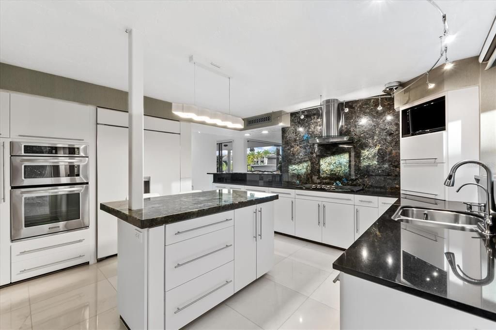 Nestled along the serene shores of Cocoanut Bayou, this captivating 4-bedroom, 4-bathroom sanctuary offers an unparalleled lifestyle for sailboat enthusiasts, boasting two boat lifts and panoramic water views.