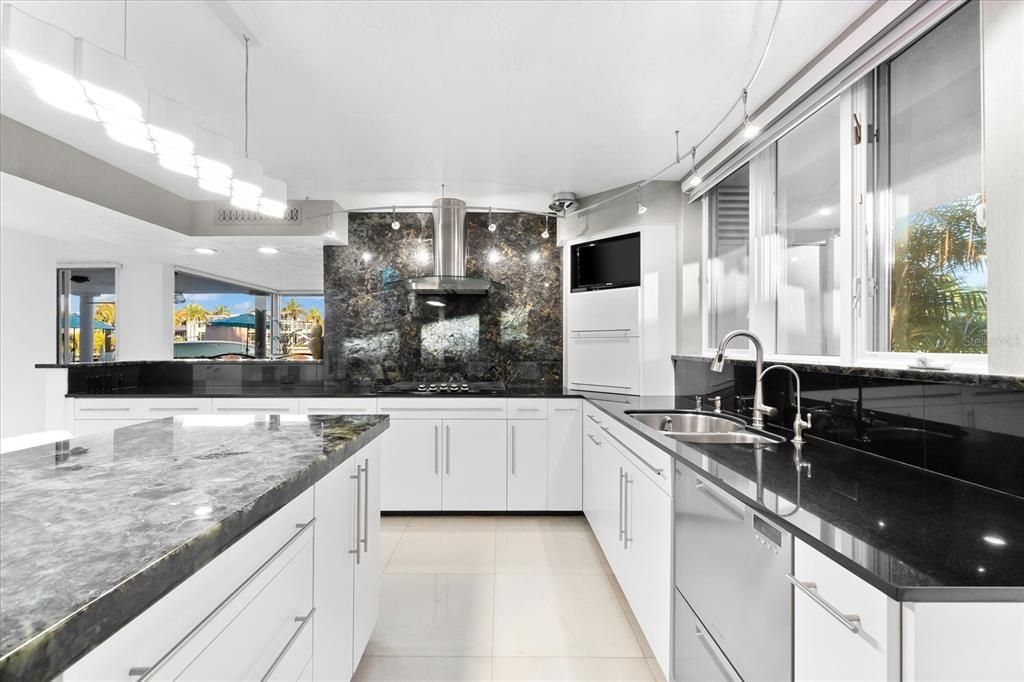 Nestled along the serene shores of Cocoanut Bayou, this captivating 4-bedroom, 4-bathroom sanctuary offers an unparalleled lifestyle for sailboat enthusiasts, boasting two boat lifts and panoramic water views.