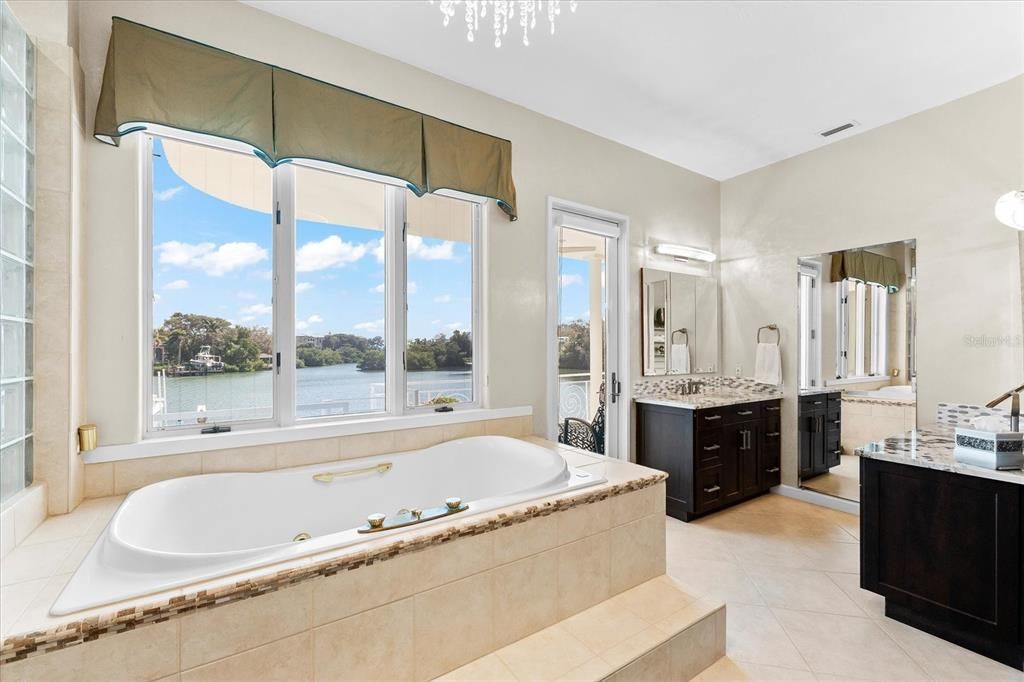 Nestled along the serene shores of Cocoanut Bayou, this captivating 4-bedroom, 4-bathroom sanctuary offers an unparalleled lifestyle for sailboat enthusiasts, boasting two boat lifts and panoramic water views.