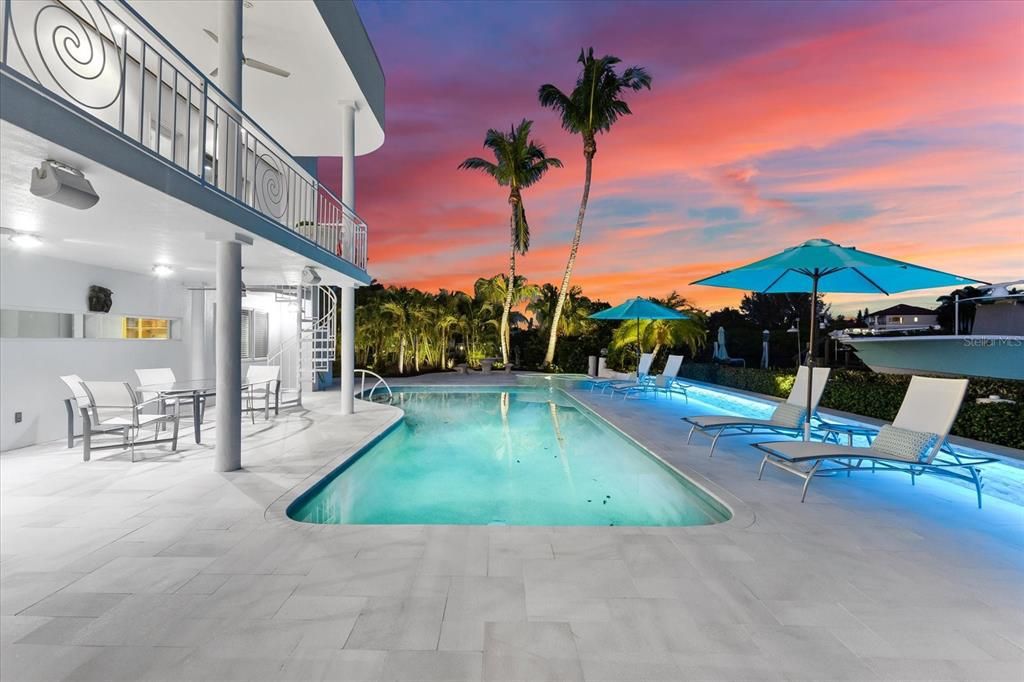 Nestled along the serene shores of Cocoanut Bayou, this captivating 4-bedroom, 4-bathroom sanctuary offers an unparalleled lifestyle for sailboat enthusiasts, boasting two boat lifts and panoramic water views.