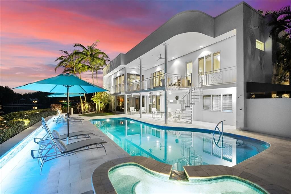 Nestled along the serene shores of Cocoanut Bayou, this captivating 4-bedroom, 4-bathroom sanctuary offers an unparalleled lifestyle for sailboat enthusiasts, boasting two boat lifts and panoramic water views.