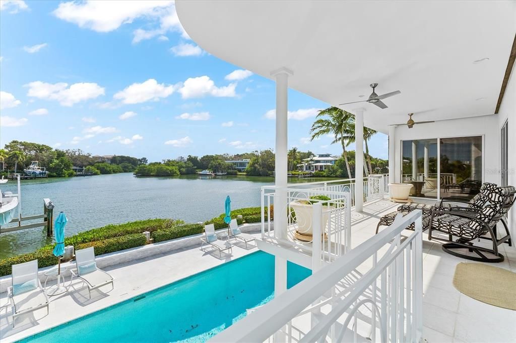 Nestled along the serene shores of Cocoanut Bayou, this captivating 4-bedroom, 4-bathroom sanctuary offers an unparalleled lifestyle for sailboat enthusiasts, boasting two boat lifts and panoramic water views.