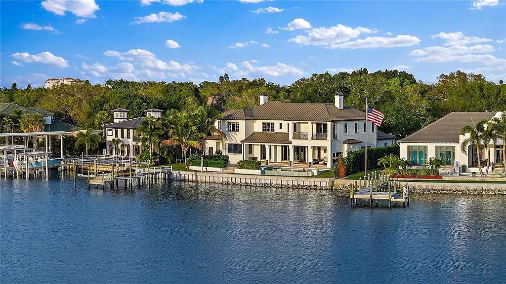 Indulge in the pinnacle of waterfront luxury living at 117 Bay Point Dr NE, Saint Petersburg, FL 33704. This exquisite property, nestled within the exclusive island enclave of Snell Isle, offers captivating ocean views from nearly every room, ensuring privacy and exclusivity among only 30 other houses.