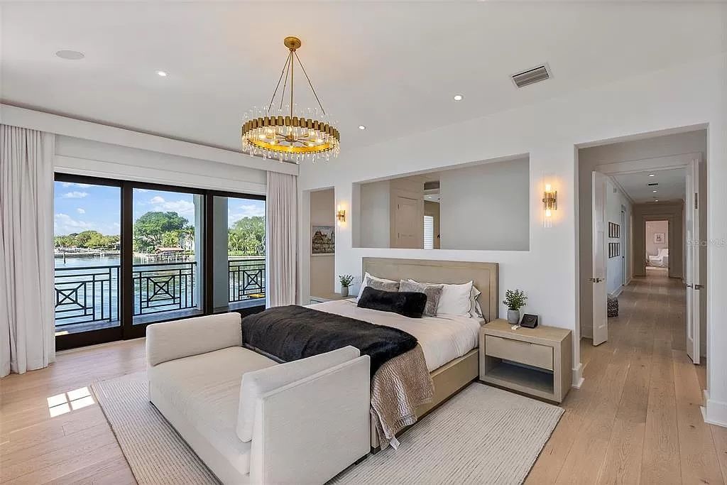 Indulge in the pinnacle of waterfront luxury living at 117 Bay Point Dr NE, Saint Petersburg, FL 33704. This exquisite property, nestled within the exclusive island enclave of Snell Isle, offers captivating ocean views from nearly every room, ensuring privacy and exclusivity among only 30 other houses.