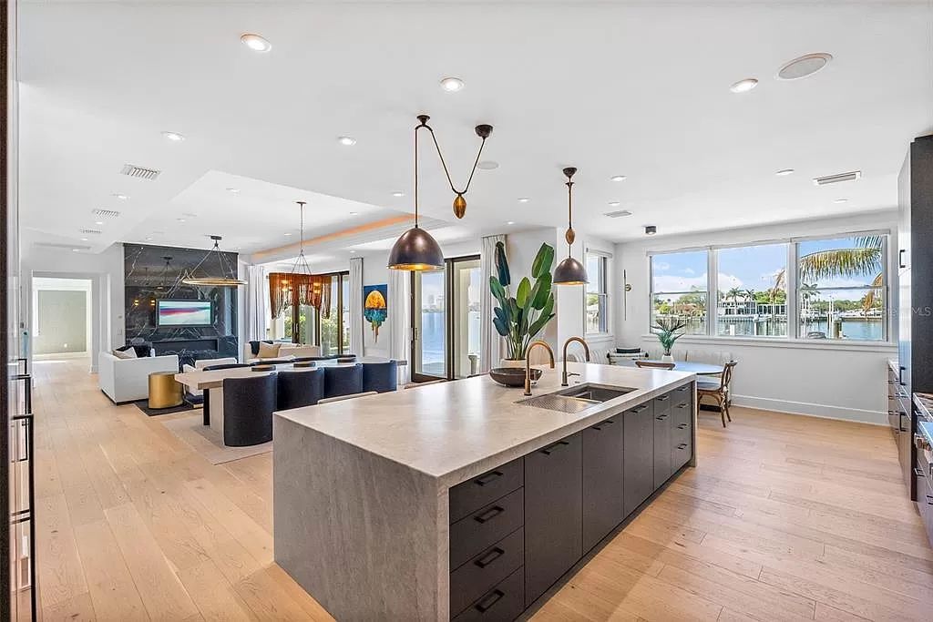 Indulge in the pinnacle of waterfront luxury living at 117 Bay Point Dr NE, Saint Petersburg, FL 33704. This exquisite property, nestled within the exclusive island enclave of Snell Isle, offers captivating ocean views from nearly every room, ensuring privacy and exclusivity among only 30 other houses.