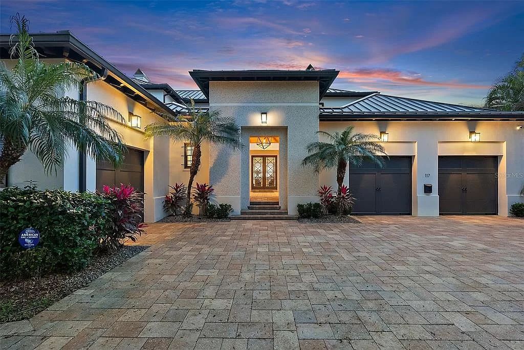 Indulge in the pinnacle of waterfront luxury living at 117 Bay Point Dr NE, Saint Petersburg, FL 33704. This exquisite property, nestled within the exclusive island enclave of Snell Isle, offers captivating ocean views from nearly every room, ensuring privacy and exclusivity among only 30 other houses.