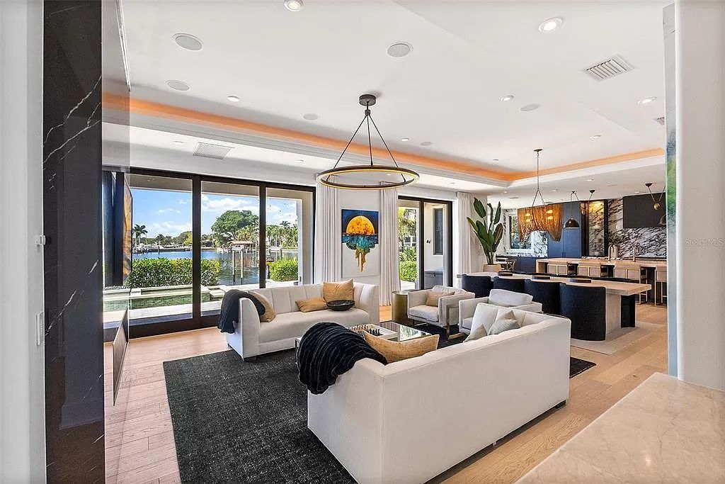 Indulge in the pinnacle of waterfront luxury living at 117 Bay Point Dr NE, Saint Petersburg, FL 33704. This exquisite property, nestled within the exclusive island enclave of Snell Isle, offers captivating ocean views from nearly every room, ensuring privacy and exclusivity among only 30 other houses.