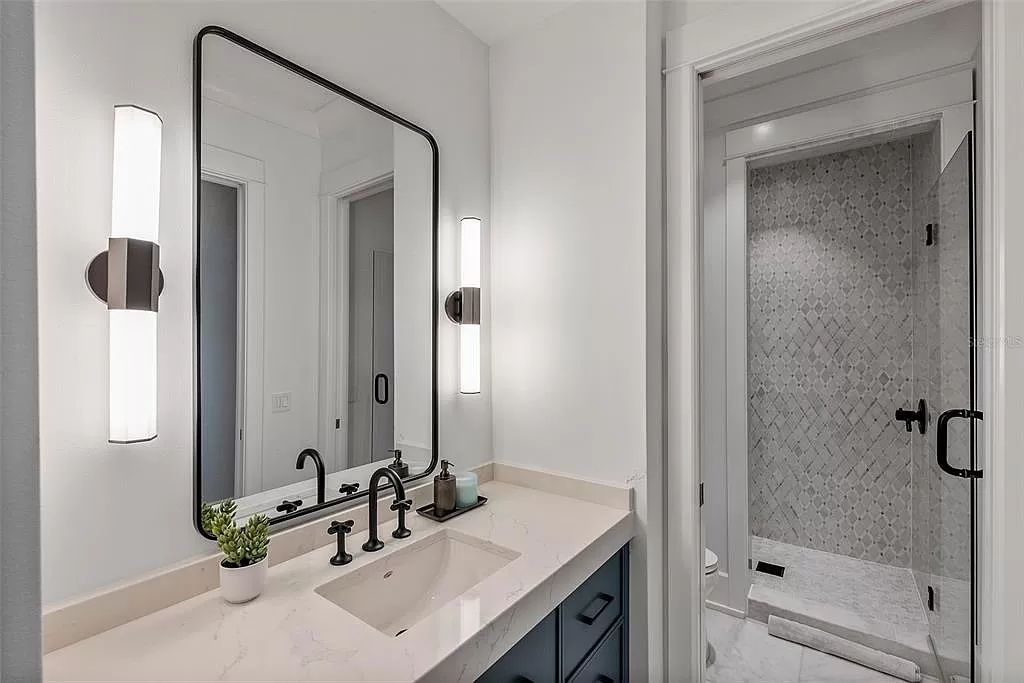 Indulge in the pinnacle of waterfront luxury living at 117 Bay Point Dr NE, Saint Petersburg, FL 33704. This exquisite property, nestled within the exclusive island enclave of Snell Isle, offers captivating ocean views from nearly every room, ensuring privacy and exclusivity among only 30 other houses.