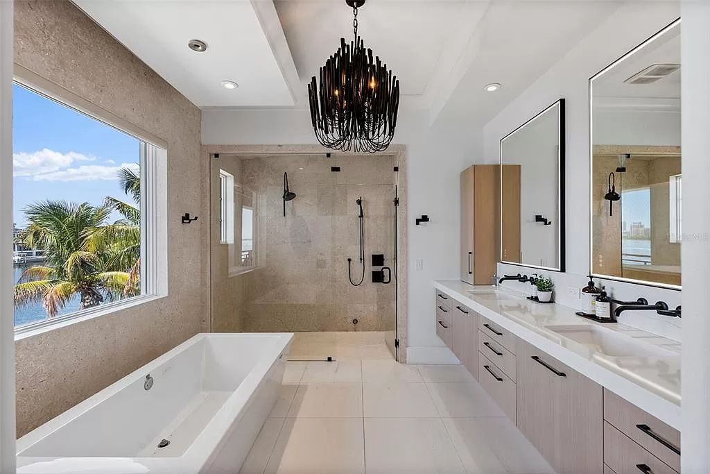 Indulge in the pinnacle of waterfront luxury living at 117 Bay Point Dr NE, Saint Petersburg, FL 33704. This exquisite property, nestled within the exclusive island enclave of Snell Isle, offers captivating ocean views from nearly every room, ensuring privacy and exclusivity among only 30 other houses.