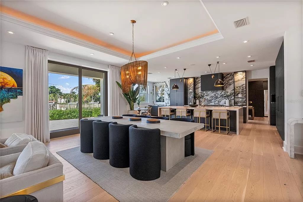Indulge in the pinnacle of waterfront luxury living at 117 Bay Point Dr NE, Saint Petersburg, FL 33704. This exquisite property, nestled within the exclusive island enclave of Snell Isle, offers captivating ocean views from nearly every room, ensuring privacy and exclusivity among only 30 other houses.