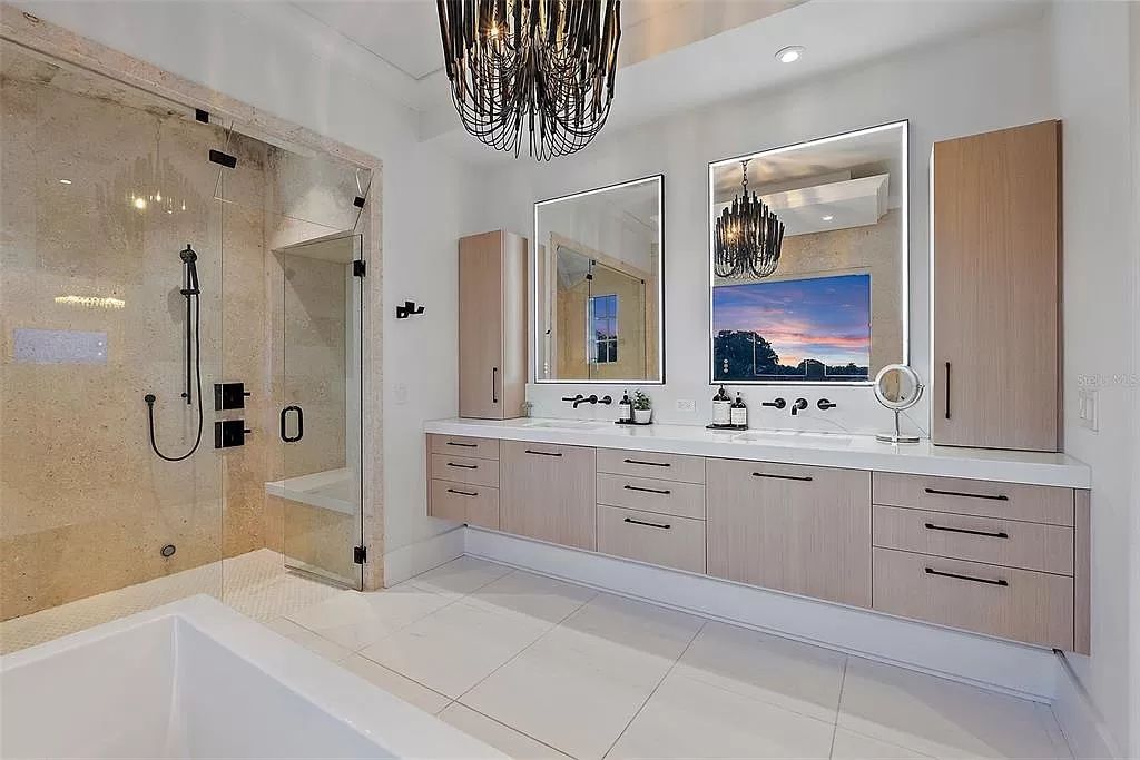 Indulge in the pinnacle of waterfront luxury living at 117 Bay Point Dr NE, Saint Petersburg, FL 33704. This exquisite property, nestled within the exclusive island enclave of Snell Isle, offers captivating ocean views from nearly every room, ensuring privacy and exclusivity among only 30 other houses.