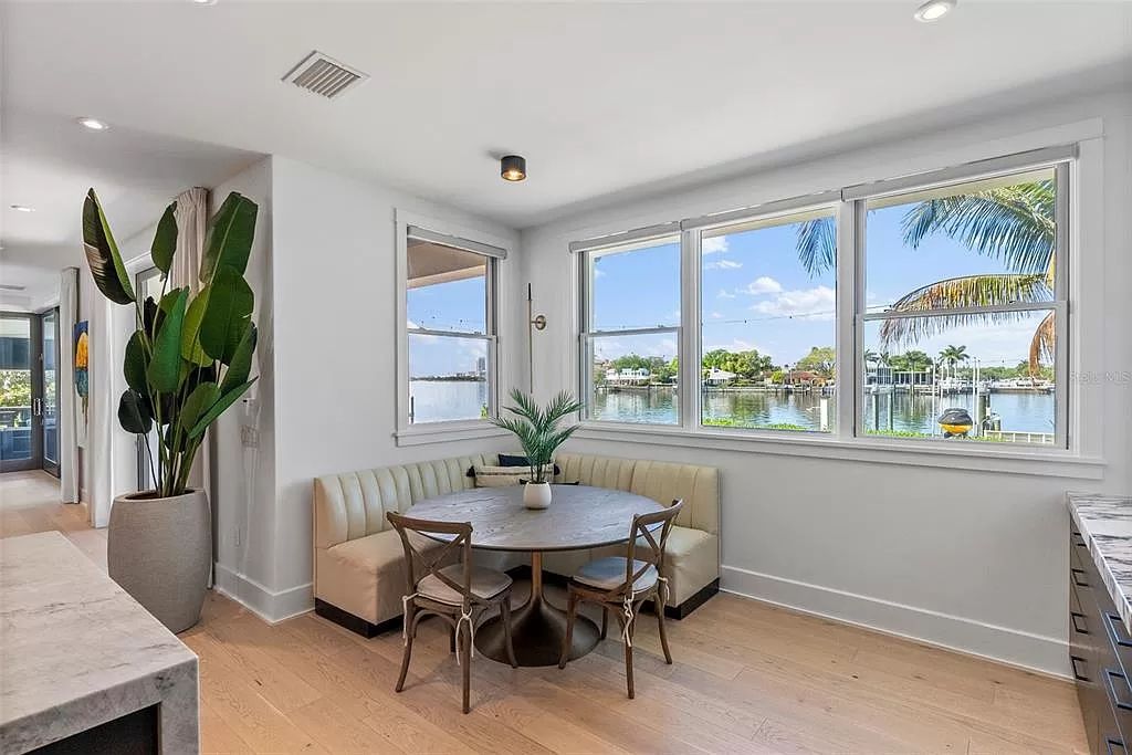 Indulge in the pinnacle of waterfront luxury living at 117 Bay Point Dr NE, Saint Petersburg, FL 33704. This exquisite property, nestled within the exclusive island enclave of Snell Isle, offers captivating ocean views from nearly every room, ensuring privacy and exclusivity among only 30 other houses.