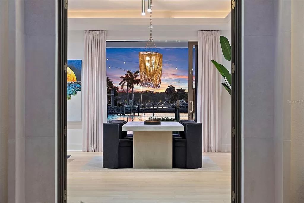 Indulge in the pinnacle of waterfront luxury living at 117 Bay Point Dr NE, Saint Petersburg, FL 33704. This exquisite property, nestled within the exclusive island enclave of Snell Isle, offers captivating ocean views from nearly every room, ensuring privacy and exclusivity among only 30 other houses.