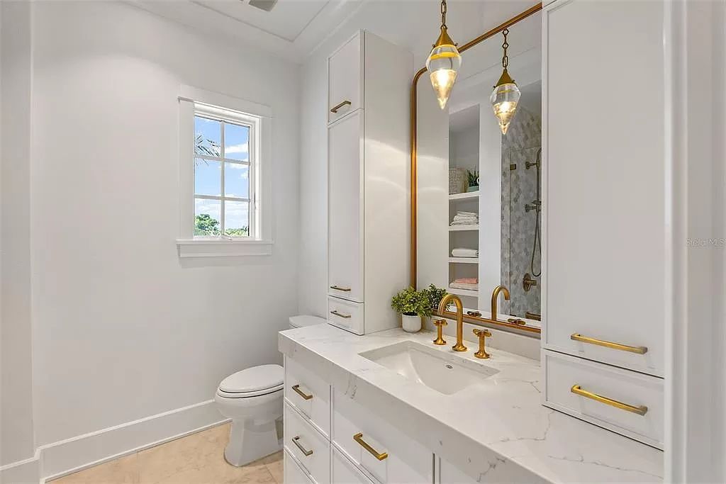 Indulge in the pinnacle of waterfront luxury living at 117 Bay Point Dr NE, Saint Petersburg, FL 33704. This exquisite property, nestled within the exclusive island enclave of Snell Isle, offers captivating ocean views from nearly every room, ensuring privacy and exclusivity among only 30 other houses.