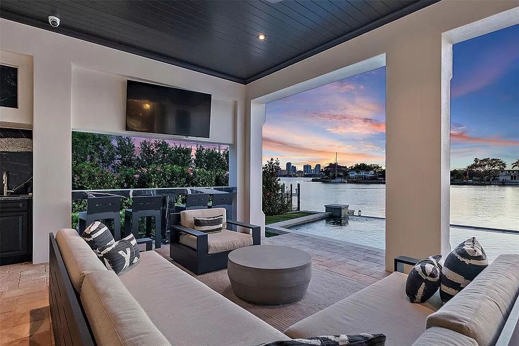 Indulge in the pinnacle of waterfront luxury living at 117 Bay Point Dr NE, Saint Petersburg, FL 33704. This exquisite property, nestled within the exclusive island enclave of Snell Isle, offers captivating ocean views from nearly every room, ensuring privacy and exclusivity among only 30 other houses.