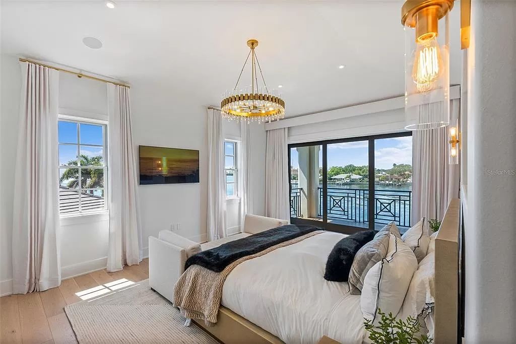 Indulge in the pinnacle of waterfront luxury living at 117 Bay Point Dr NE, Saint Petersburg, FL 33704. This exquisite property, nestled within the exclusive island enclave of Snell Isle, offers captivating ocean views from nearly every room, ensuring privacy and exclusivity among only 30 other houses.