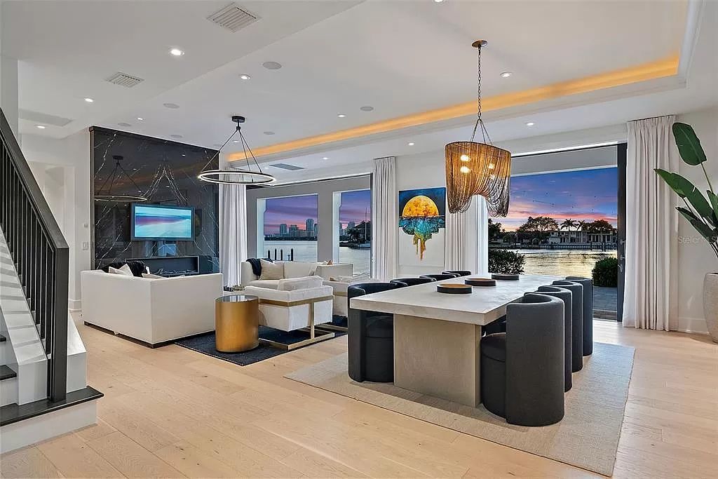 Indulge in the pinnacle of waterfront luxury living at 117 Bay Point Dr NE, Saint Petersburg, FL 33704. This exquisite property, nestled within the exclusive island enclave of Snell Isle, offers captivating ocean views from nearly every room, ensuring privacy and exclusivity among only 30 other houses.