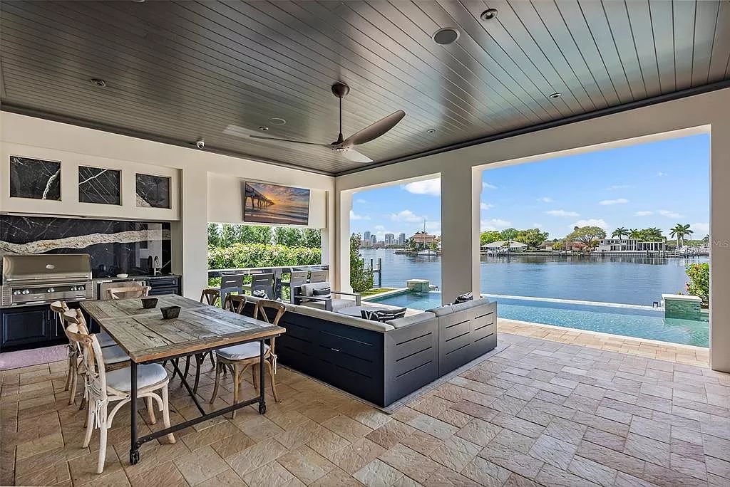 Indulge in the pinnacle of waterfront luxury living at 117 Bay Point Dr NE, Saint Petersburg, FL 33704. This exquisite property, nestled within the exclusive island enclave of Snell Isle, offers captivating ocean views from nearly every room, ensuring privacy and exclusivity among only 30 other houses.