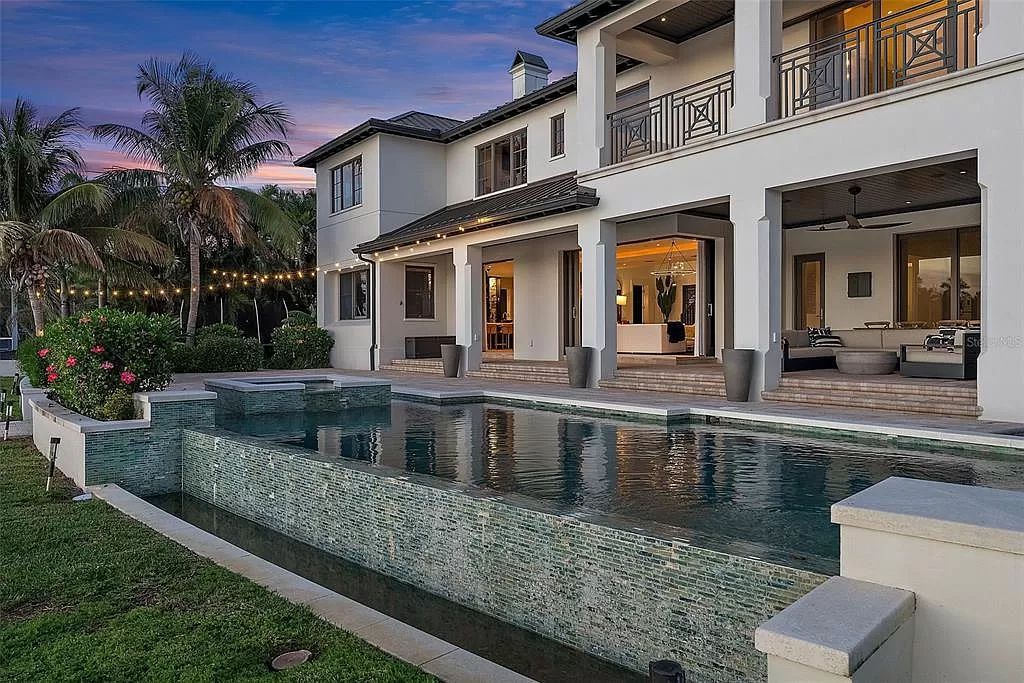 Indulge in the pinnacle of waterfront luxury living at 117 Bay Point Dr NE, Saint Petersburg, FL 33704. This exquisite property, nestled within the exclusive island enclave of Snell Isle, offers captivating ocean views from nearly every room, ensuring privacy and exclusivity among only 30 other houses.