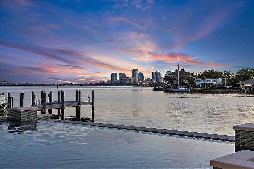 Indulge in the pinnacle of waterfront luxury living at 117 Bay Point Dr NE, Saint Petersburg, FL 33704. This exquisite property, nestled within the exclusive island enclave of Snell Isle, offers captivating ocean views from nearly every room, ensuring privacy and exclusivity among only 30 other houses.