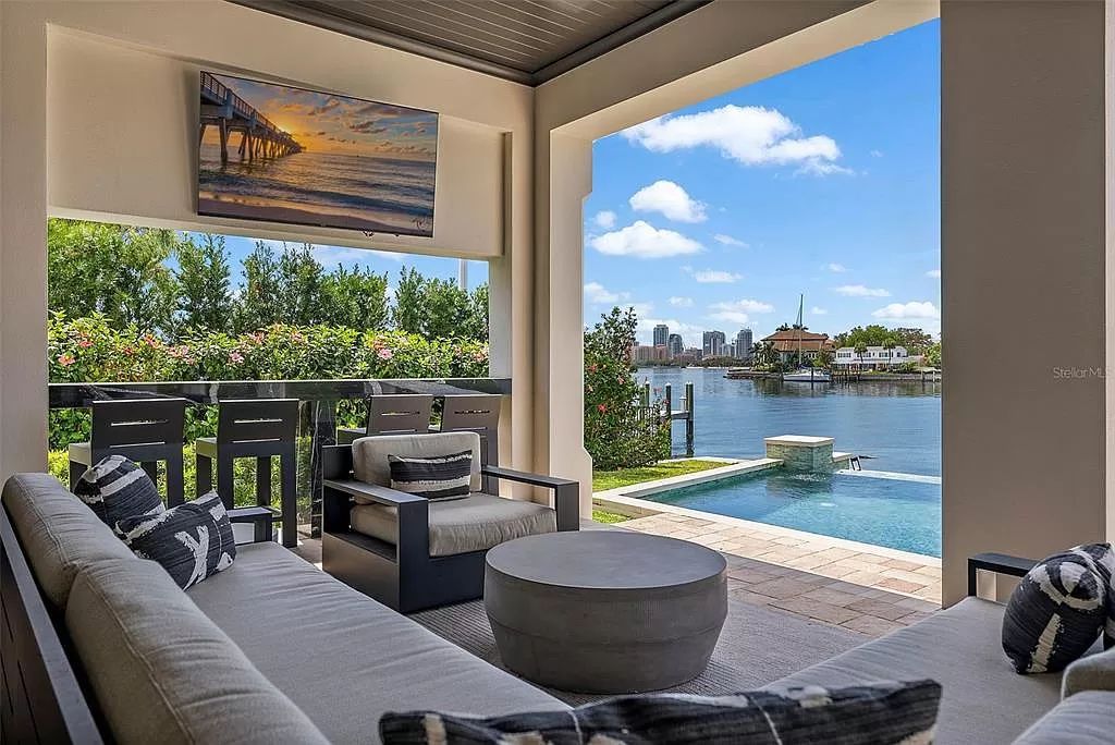 Indulge in the pinnacle of waterfront luxury living at 117 Bay Point Dr NE, Saint Petersburg, FL 33704. This exquisite property, nestled within the exclusive island enclave of Snell Isle, offers captivating ocean views from nearly every room, ensuring privacy and exclusivity among only 30 other houses.