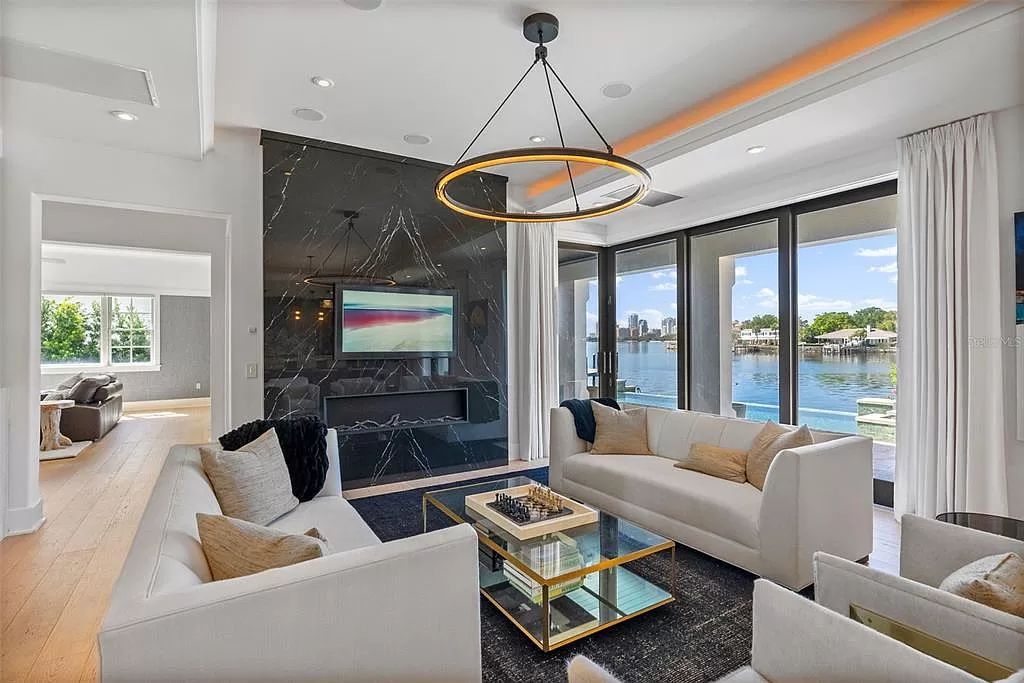 Indulge in the pinnacle of waterfront luxury living at 117 Bay Point Dr NE, Saint Petersburg, FL 33704. This exquisite property, nestled within the exclusive island enclave of Snell Isle, offers captivating ocean views from nearly every room, ensuring privacy and exclusivity among only 30 other houses.
