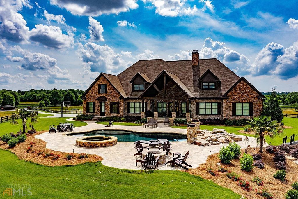 1211 Owens Gin Road NE Home in Calhoun, Georgia. Explore the beauty of this 39.55-acre farm nestled in Northwest Georgia, featuring a stunning home overlooking a stocked lake and the Coosawattee River.