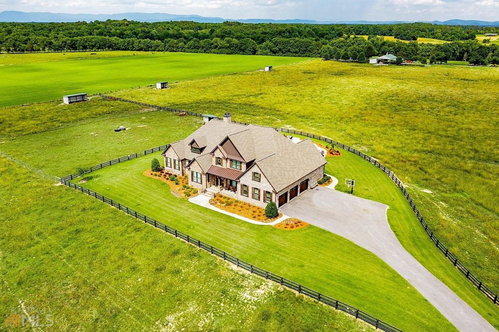 1211 Owens Gin Road NE Home in Calhoun, Georgia. Explore the beauty of this 39.55-acre farm nestled in Northwest Georgia, featuring a stunning home overlooking a stocked lake and the Coosawattee River.