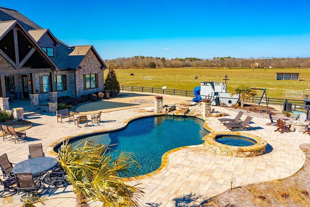 1211 Owens Gin Road NE Home in Calhoun, Georgia. Explore the beauty of this 39.55-acre farm nestled in Northwest Georgia, featuring a stunning home overlooking a stocked lake and the Coosawattee River.