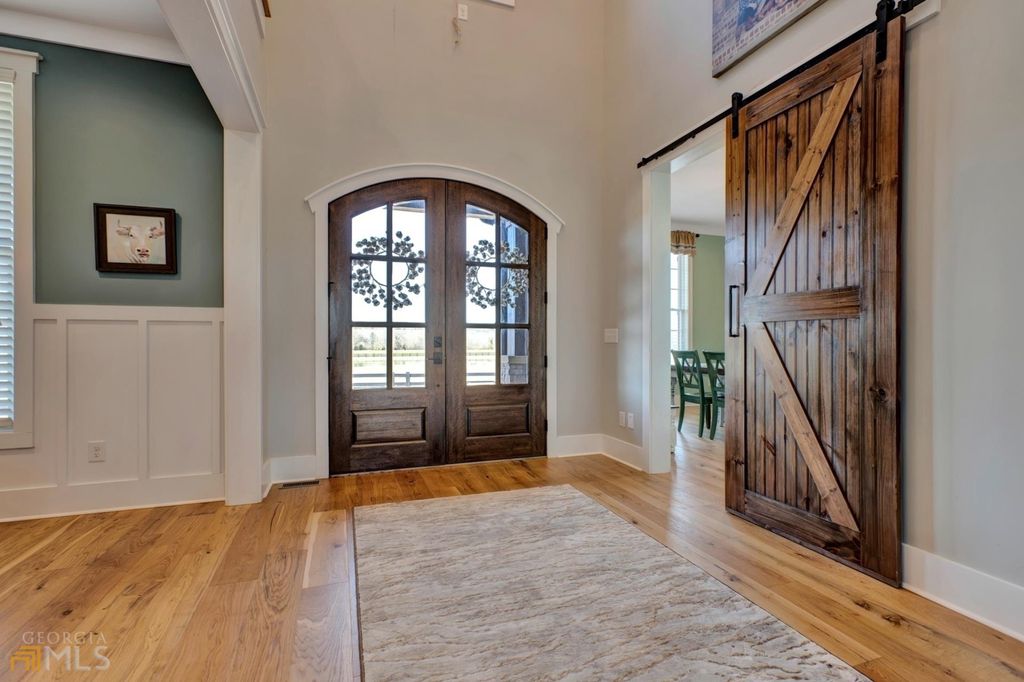 1211 Owens Gin Road NE Home in Calhoun, Georgia. Explore the beauty of this 39.55-acre farm nestled in Northwest Georgia, featuring a stunning home overlooking a stocked lake and the Coosawattee River.