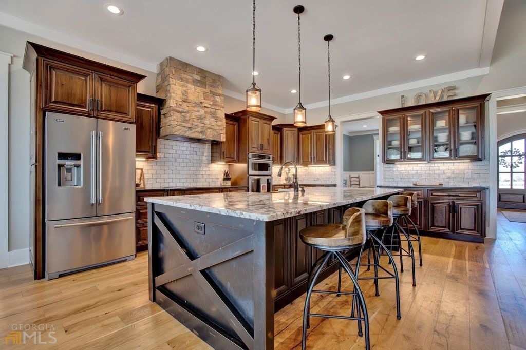 1211 Owens Gin Road NE Home in Calhoun, Georgia. Explore the beauty of this 39.55-acre farm nestled in Northwest Georgia, featuring a stunning home overlooking a stocked lake and the Coosawattee River.