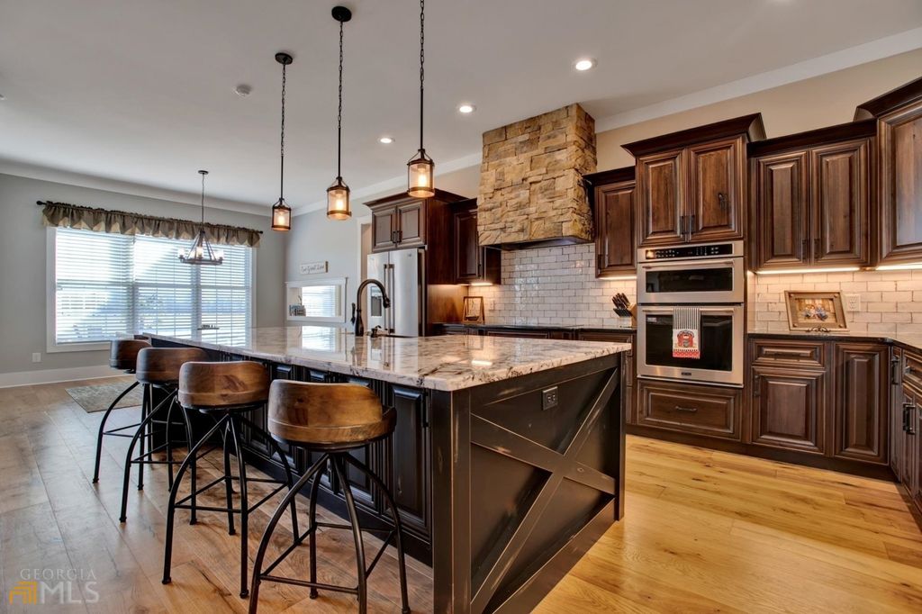 1211 Owens Gin Road NE Home in Calhoun, Georgia. Explore the beauty of this 39.55-acre farm nestled in Northwest Georgia, featuring a stunning home overlooking a stocked lake and the Coosawattee River.