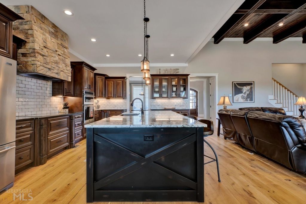 1211 Owens Gin Road NE Home in Calhoun, Georgia. Explore the beauty of this 39.55-acre farm nestled in Northwest Georgia, featuring a stunning home overlooking a stocked lake and the Coosawattee River.