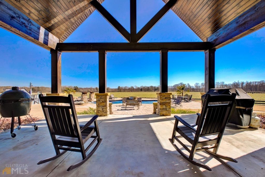 1211 Owens Gin Road NE Home in Calhoun, Georgia. Explore the beauty of this 39.55-acre farm nestled in Northwest Georgia, featuring a stunning home overlooking a stocked lake and the Coosawattee River.