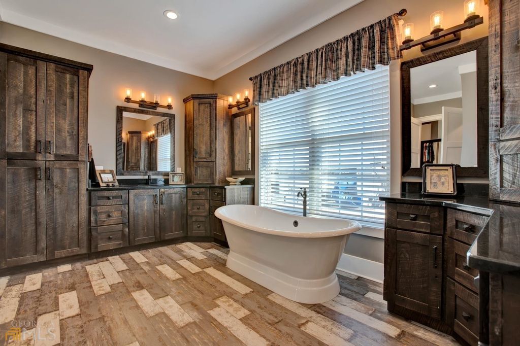 1211 Owens Gin Road NE Home in Calhoun, Georgia. Explore the beauty of this 39.55-acre farm nestled in Northwest Georgia, featuring a stunning home overlooking a stocked lake and the Coosawattee River.