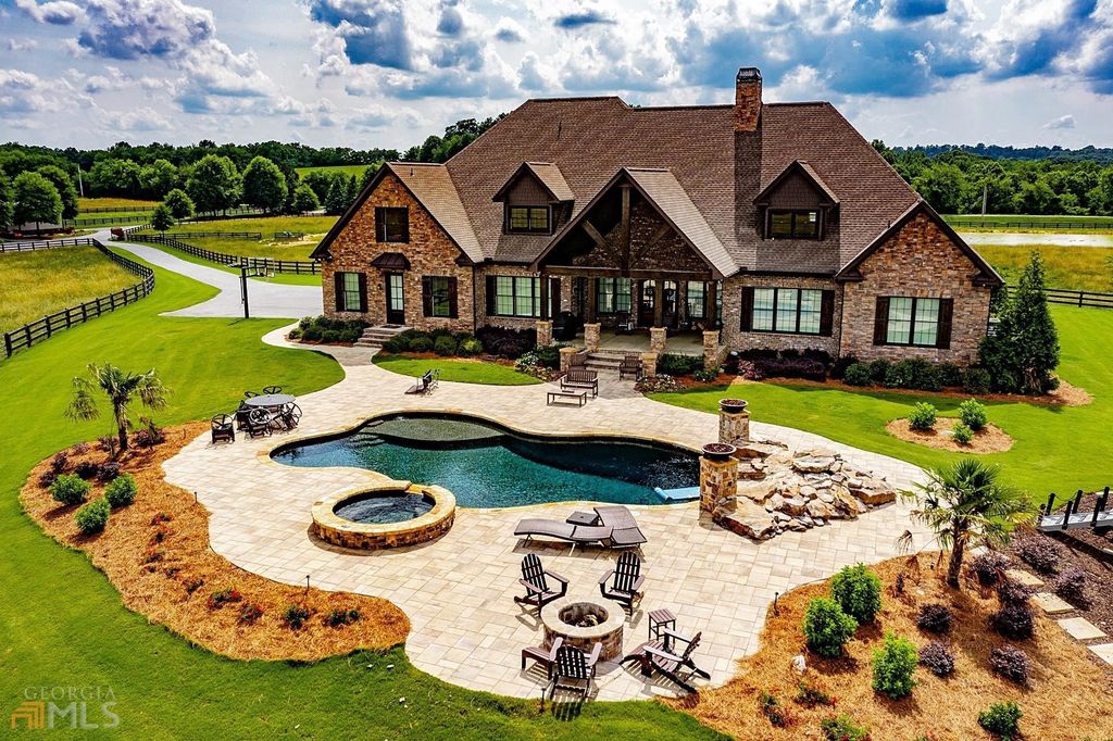 1211 Owens Gin Road NE Home in Calhoun, Georgia. Explore the beauty of this 39.55-acre farm nestled in Northwest Georgia, featuring a stunning home overlooking a stocked lake and the Coosawattee River.