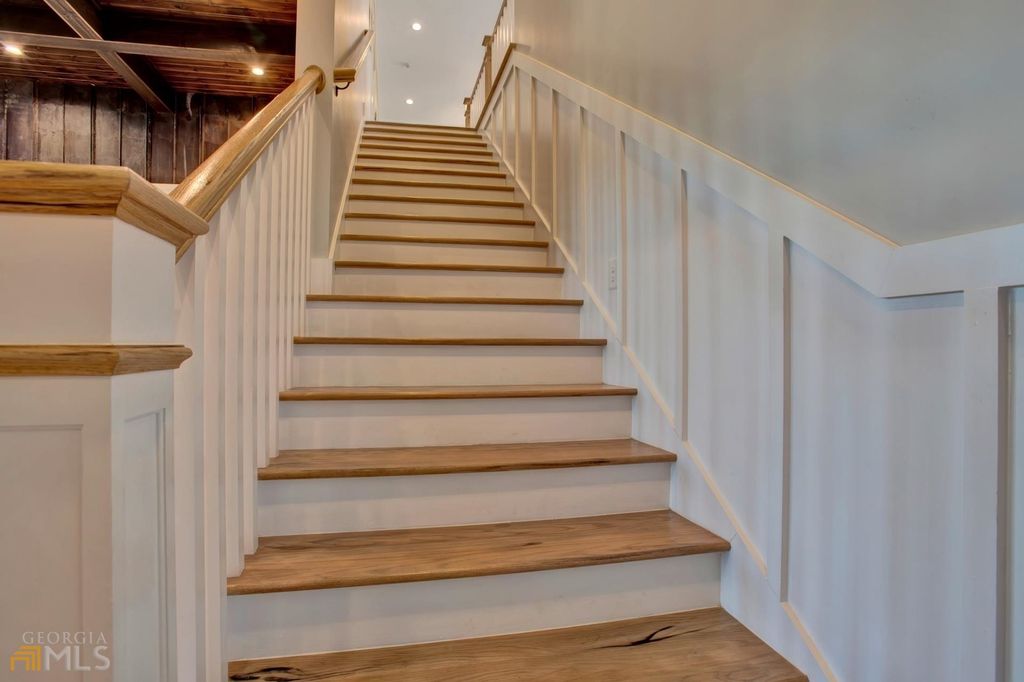 1211 Owens Gin Road NE Home in Calhoun, Georgia. Explore the beauty of this 39.55-acre farm nestled in Northwest Georgia, featuring a stunning home overlooking a stocked lake and the Coosawattee River.