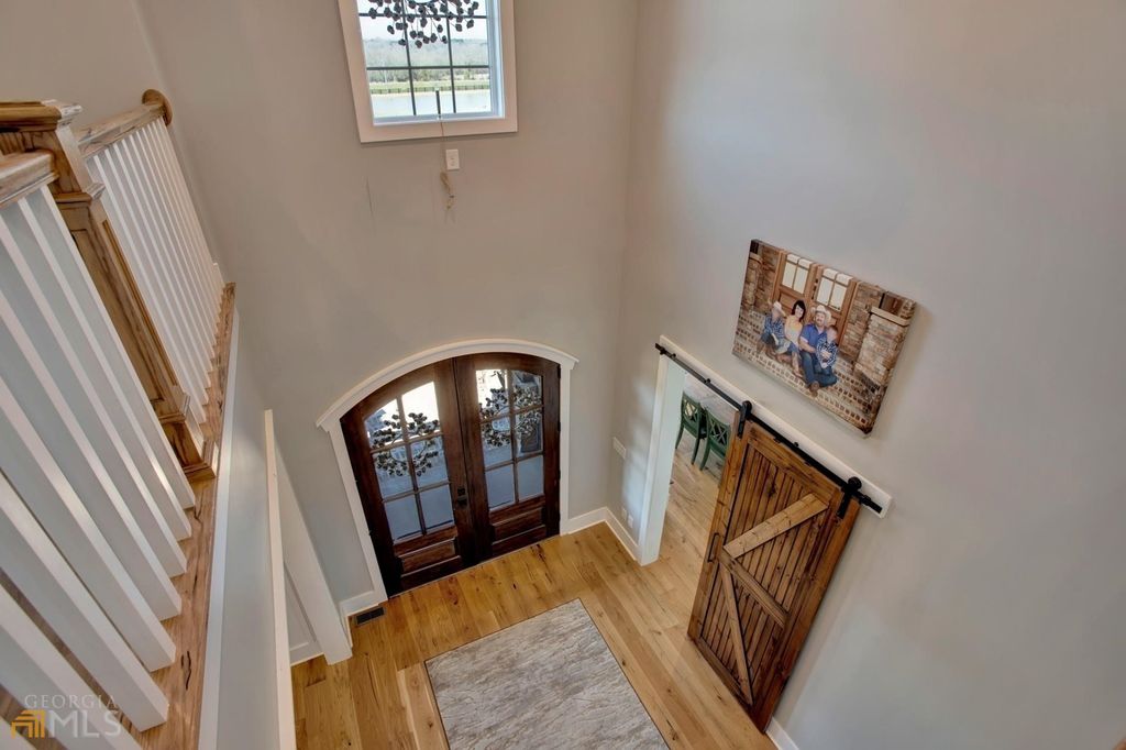 1211 Owens Gin Road NE Home in Calhoun, Georgia. Explore the beauty of this 39.55-acre farm nestled in Northwest Georgia, featuring a stunning home overlooking a stocked lake and the Coosawattee River.