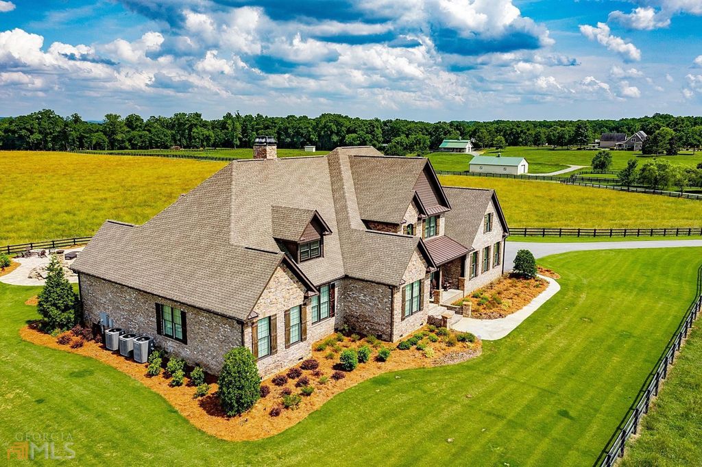 1211 Owens Gin Road NE Home in Calhoun, Georgia. Explore the beauty of this 39.55-acre farm nestled in Northwest Georgia, featuring a stunning home overlooking a stocked lake and the Coosawattee River.