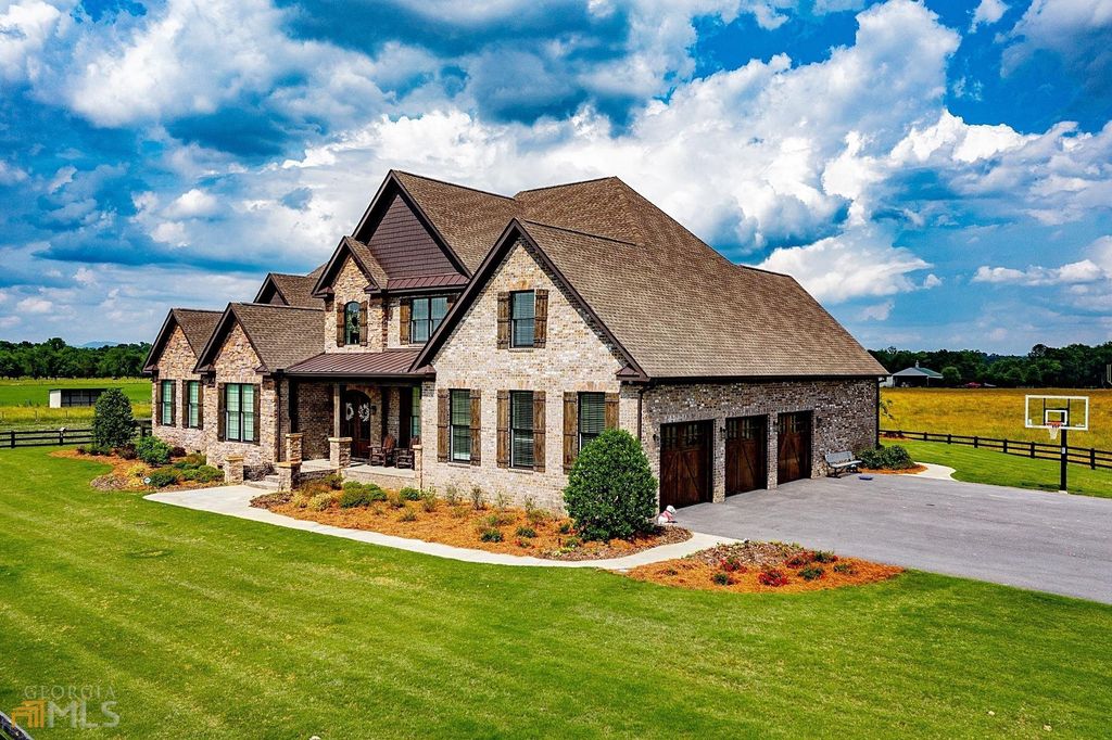 1211 Owens Gin Road NE Home in Calhoun, Georgia. Explore the beauty of this 39.55-acre farm nestled in Northwest Georgia, featuring a stunning home overlooking a stocked lake and the Coosawattee River.