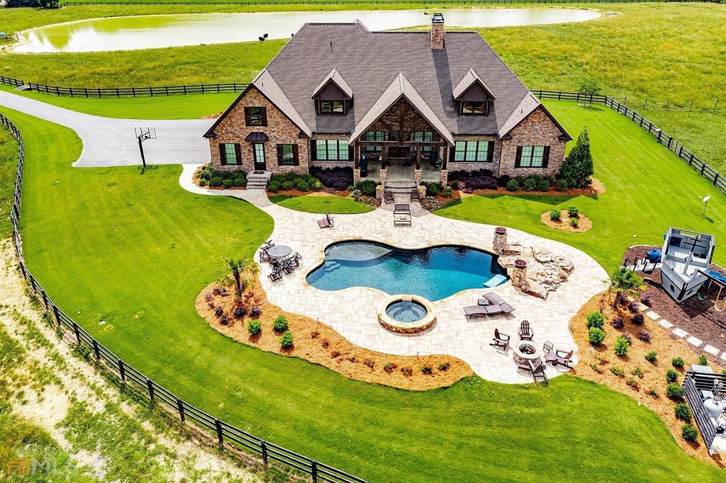 1211 Owens Gin Road NE Home in Calhoun, Georgia. Explore the beauty of this 39.55-acre farm nestled in Northwest Georgia, featuring a stunning home overlooking a stocked lake and the Coosawattee River.