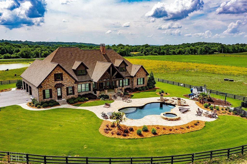 1211 Owens Gin Road NE Home in Calhoun, Georgia. Explore the beauty of this 39.55-acre farm nestled in Northwest Georgia, featuring a stunning home overlooking a stocked lake and the Coosawattee River.