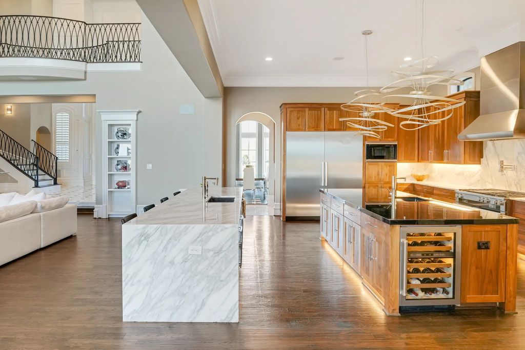 1252 Wales Drive Home in Rockwall, Texas. Step into luxury living at its finest with this illustrious estate set on over two private acres. Enjoy resort-style amenities including a pool with swim-up bar, fire features, waterfalls, and a covered patio with motorized screens.