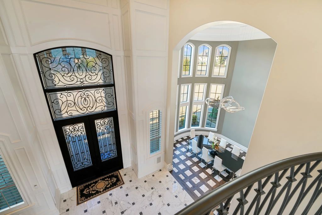 1252 Wales Drive Home in Rockwall, Texas. Step into luxury living at its finest with this illustrious estate set on over two private acres. Enjoy resort-style amenities including a pool with swim-up bar, fire features, waterfalls, and a covered patio with motorized screens.