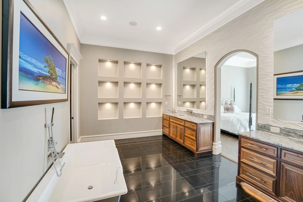 1252 Wales Drive Home in Rockwall, Texas. Step into luxury living at its finest with this illustrious estate set on over two private acres. Enjoy resort-style amenities including a pool with swim-up bar, fire features, waterfalls, and a covered patio with motorized screens.
