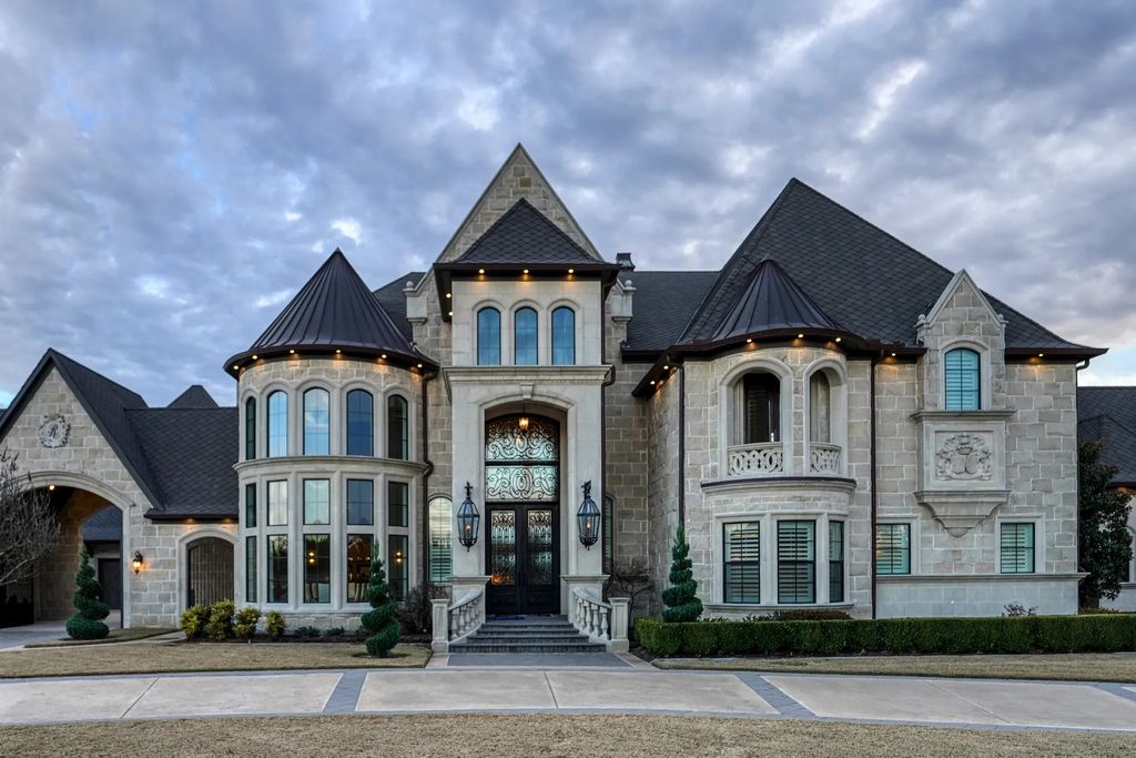 1252 Wales Drive Home in Rockwall, Texas. Step into luxury living at its finest with this illustrious estate set on over two private acres. Enjoy resort-style amenities including a pool with swim-up bar, fire features, waterfalls, and a covered patio with motorized screens.