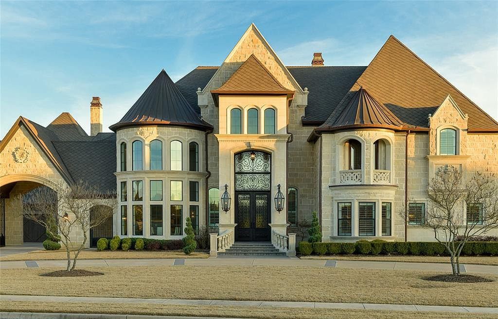 1252 Wales Drive Home in Rockwall, Texas. Step into luxury living at its finest with this illustrious estate set on over two private acres. Enjoy resort-style amenities including a pool with swim-up bar, fire features, waterfalls, and a covered patio with motorized screens.