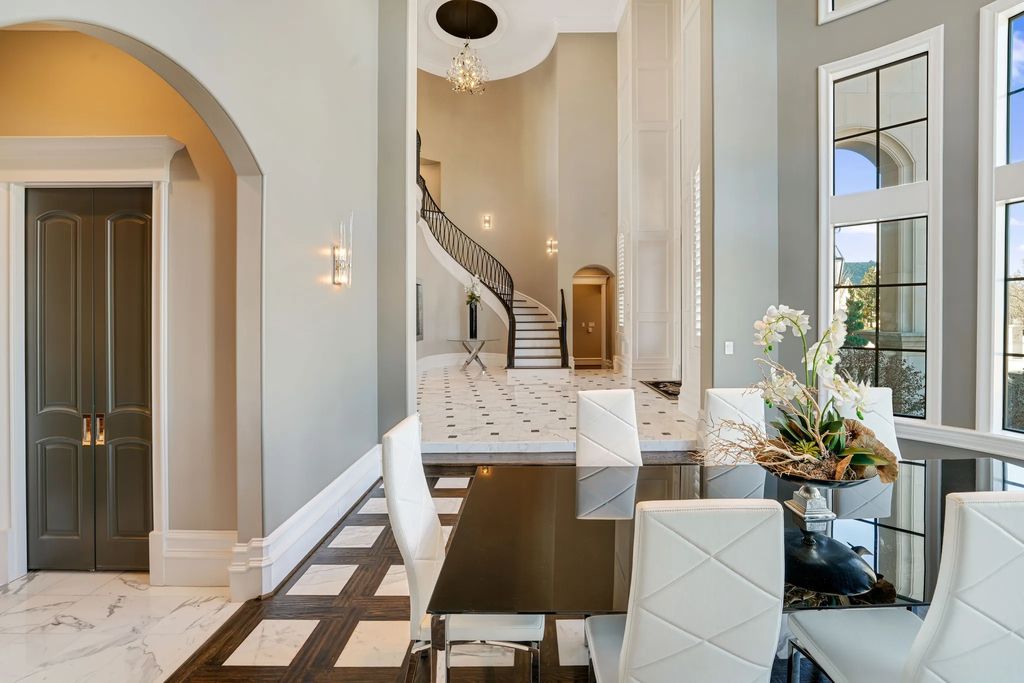 1252 Wales Drive Home in Rockwall, Texas. Step into luxury living at its finest with this illustrious estate set on over two private acres. Enjoy resort-style amenities including a pool with swim-up bar, fire features, waterfalls, and a covered patio with motorized screens.