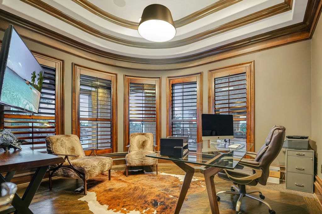 1252 Wales Drive Home in Rockwall, Texas. Step into luxury living at its finest with this illustrious estate set on over two private acres. Enjoy resort-style amenities including a pool with swim-up bar, fire features, waterfalls, and a covered patio with motorized screens.